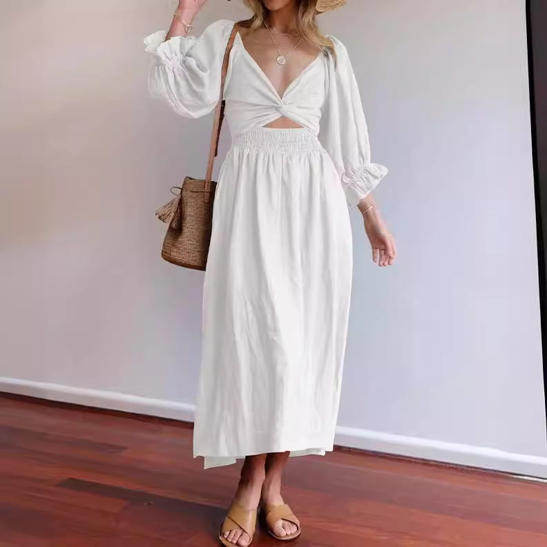 A flowing white linen v-neck lantern sleeve reversible midi dress with a deep v-neckline ruched bodice and long puffed sleeves.
