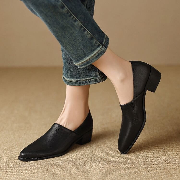 black leather slip-on loafers for women featuring a low block heel and pointed toe, designed as elegant square toe shoes.
