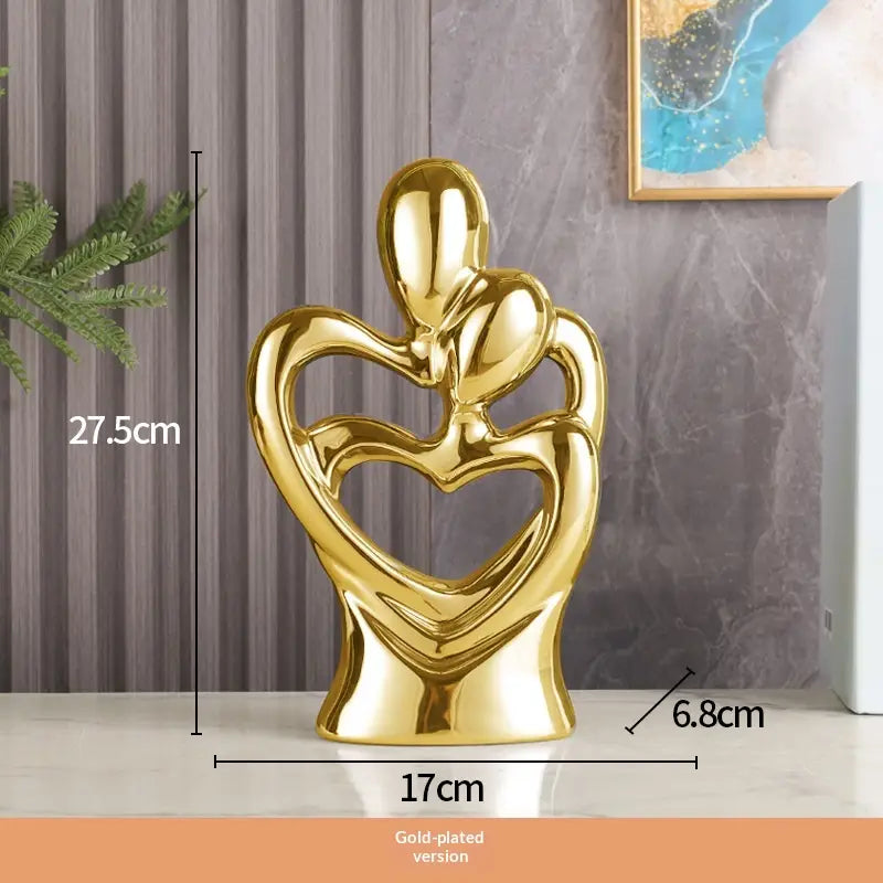 Gold-plated abstract heart ceramic figurine featuring two figures embracing as modern home decor.