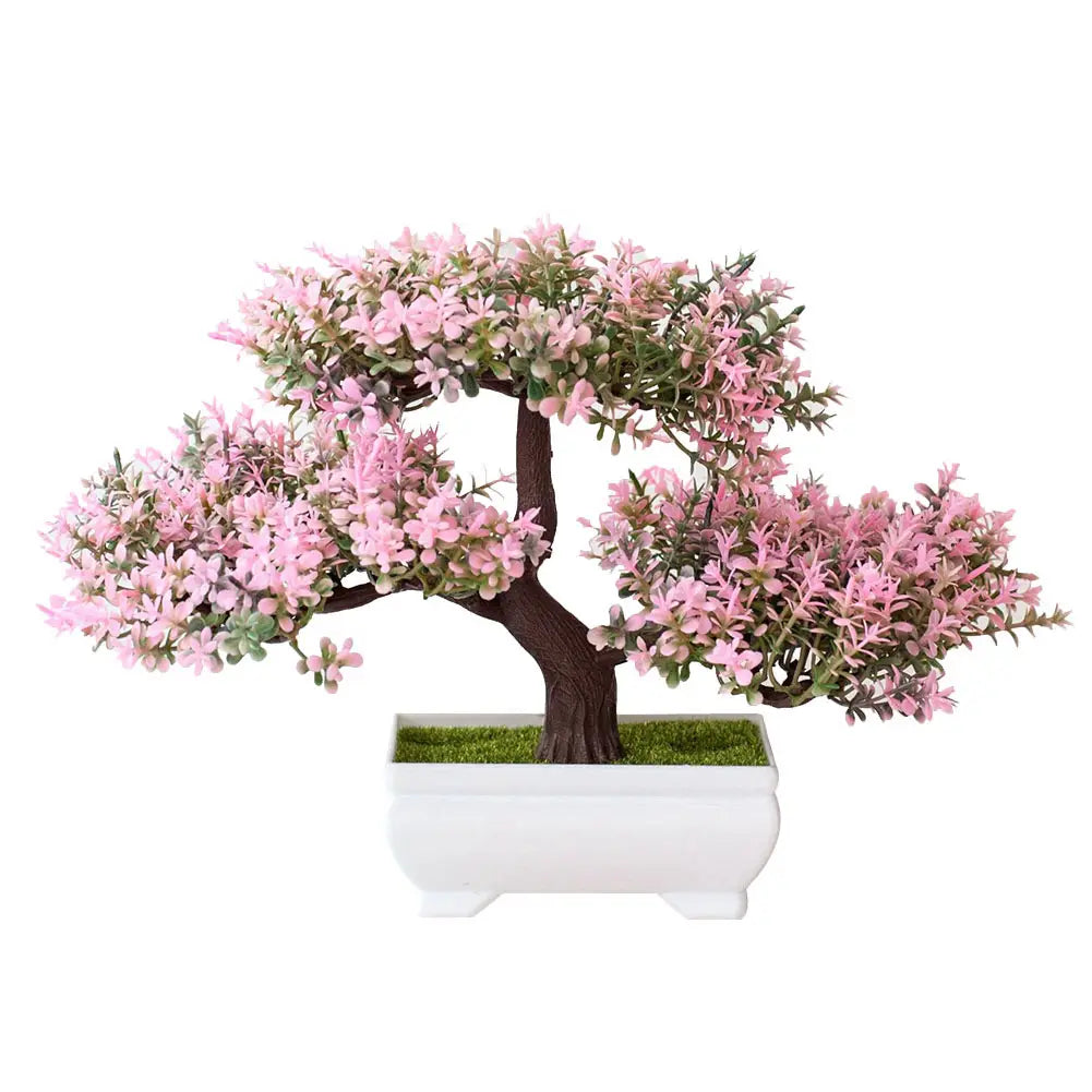 A delicate pink blossoming artificial bonsai tree with dark brown trunk and green foliage in a sleek white ceramic pot displayed as part of a four pack.