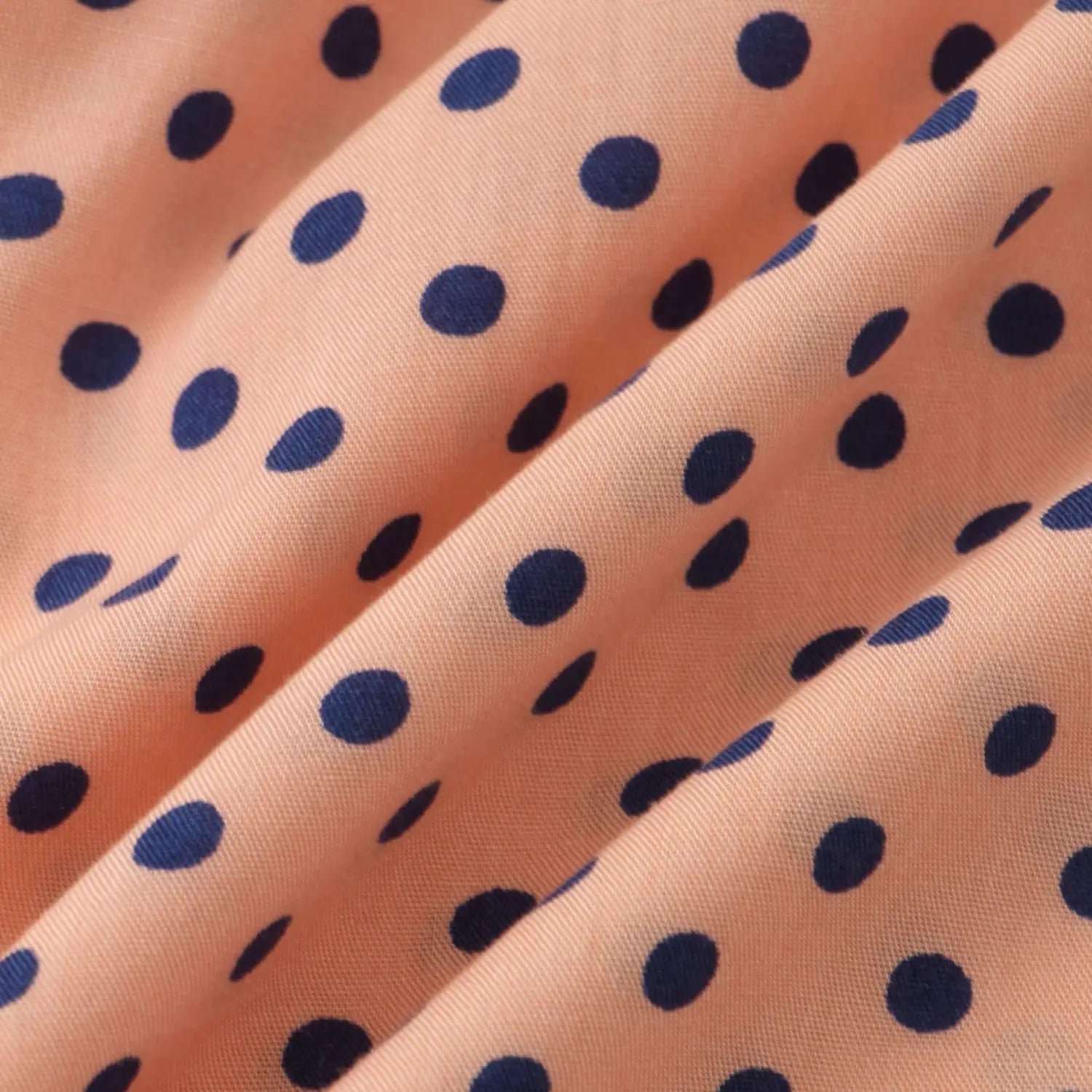 Men plus size button up shirt in peach-colored fabric with navy blue polka dot pattern.