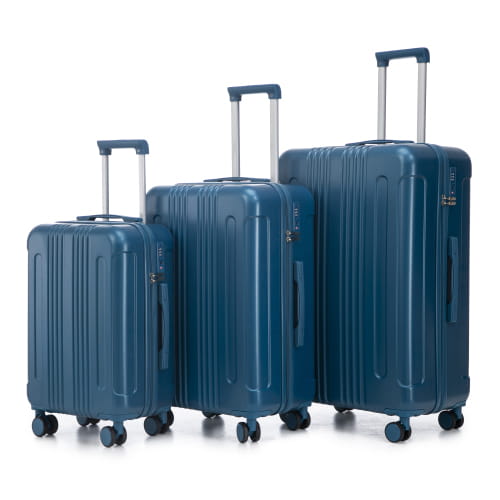 Set of three navy blue hard shell abs spinner suitcases with vertical ribbed design silver telescoping handles and tsa lock.