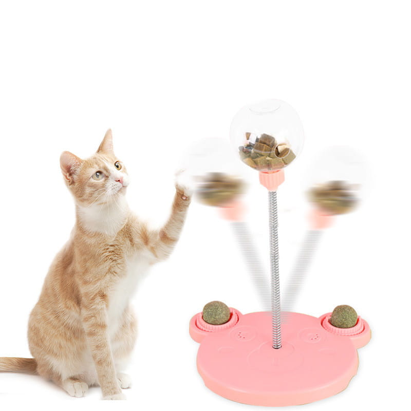 Gobelet distributeur de nourriture pour jouet puzzle interactif en plastique rose en forme de chat avec ventouse, comprenant trois sphères transparentes rotatives remplies de friandises et un mât central métallique.