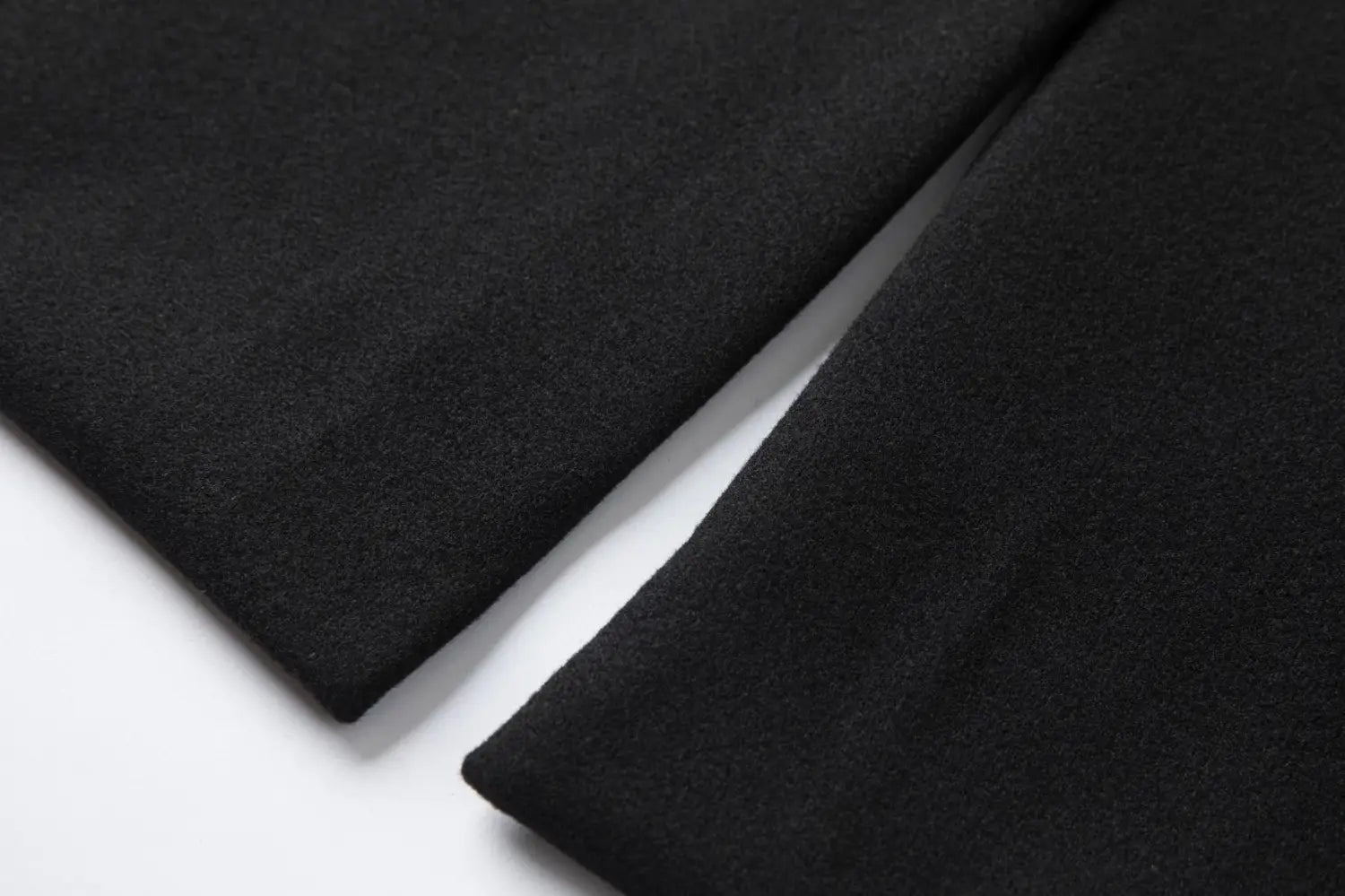 Men double breasted mid length overcoat made of soft textured black woolen fabric.