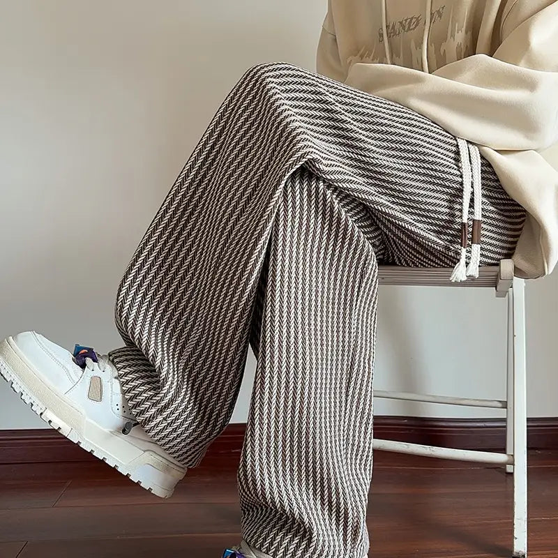 Men wide leg herringbone drawstring trousers in loose beige and dark gray fabric with a white drawstring.