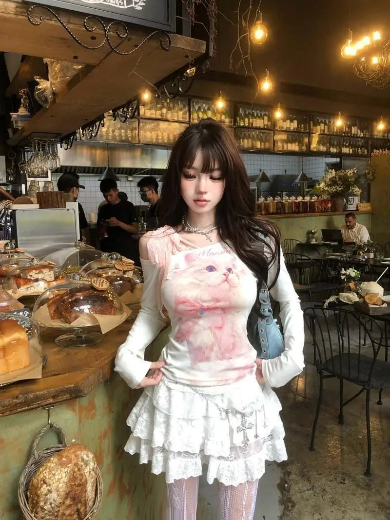 white ruffled skirt with lace trim paired with a cat print lace halter long sleeve top in a coordinated outfit.