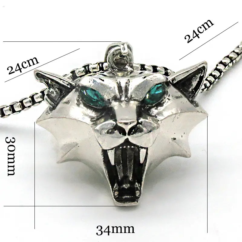 Silver panther head pendant with emerald green eyes and spiked design attached to a matching chain in a geometric wild game animal pendant chain necklace.