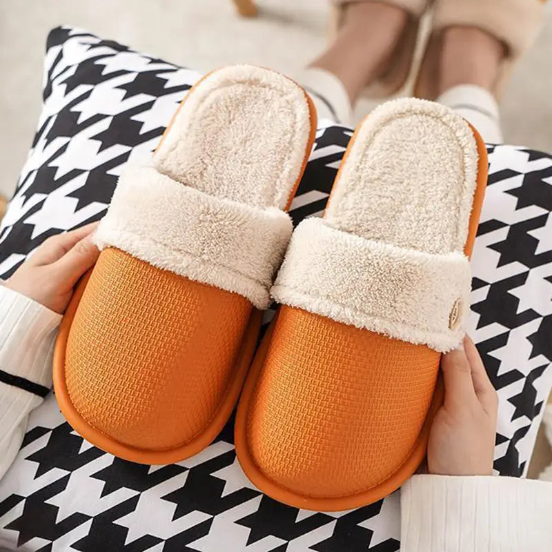 orange slip-on winter slippers with washable plush cream-colored fleece lining and textured rubber soles for women