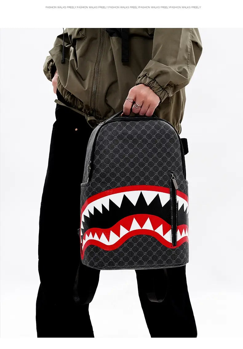 Black backpack made of PU material featuring a large capacity, bold red and white shark mouth design, and a repeating geometric pattern ideal for business use.