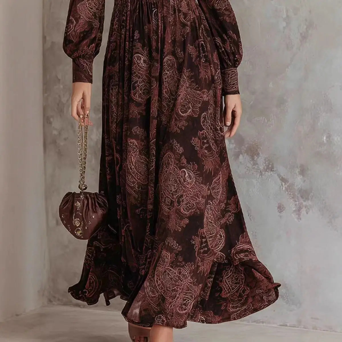 Une robe maxi marron foncé à manches longues, avec un motif cachemire bordeaux élaboré, présentant un design d’impression rétro.