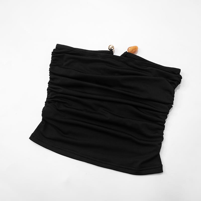 Strapless keyhole crop top in black ruched fabric with a silver-toned clasp and amber-colored accent bead.