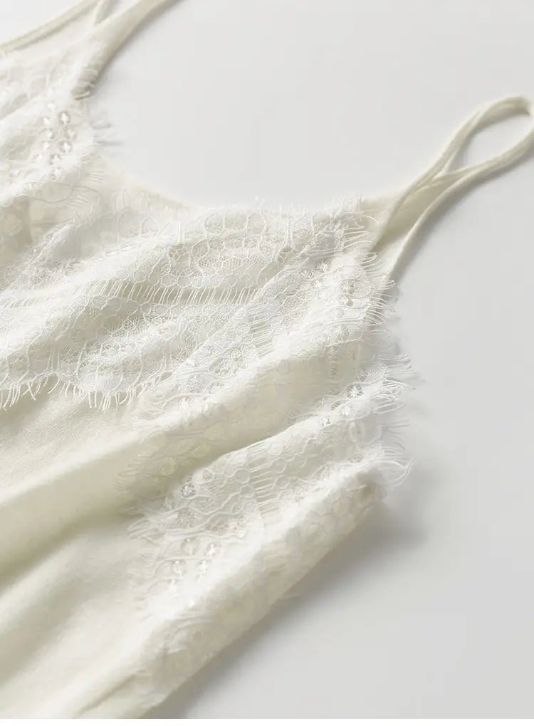 A delicate off-white lace trim camisole top featuring thin straps and subtle beading details.