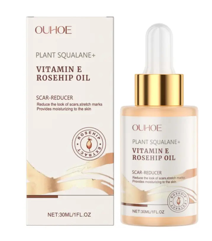 Ouhoe squalane wrinkle reducing skincare oil with vitamin e and rosehip oil in a clear glass bottle with gold dropper and cap containing amber-colored liquid.