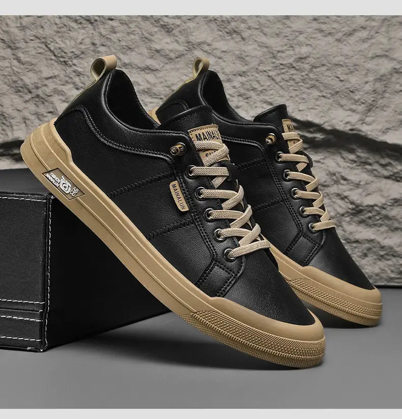 Men’s white minimalist leather casual sneakers in black leather with beige laces and tan rubber sole featuring subtle branding on the side.