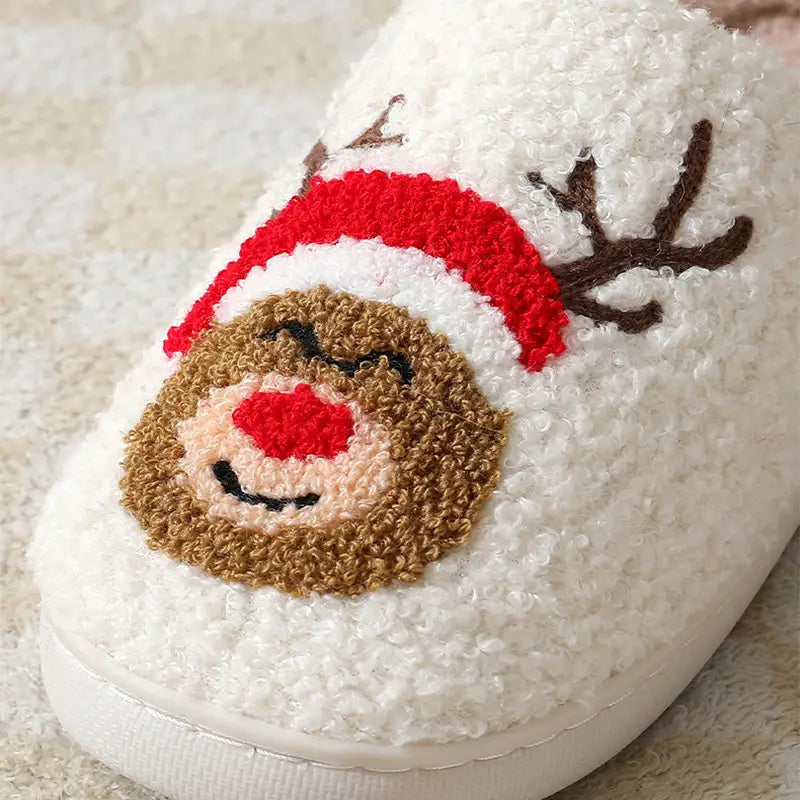 white fluffy slipper featuring a cozy embroidered reindeer face with a red hat and nose from the festive embroidered santa and reindeer winter slippers collection