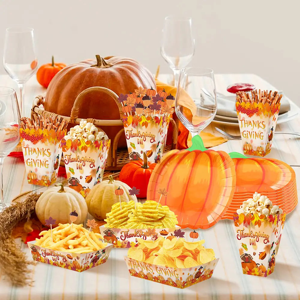 Thanksgiving pumpkin paper plates and tableware set featuring orange paper serving trays decorated with autumn leaf and pumpkin designs.