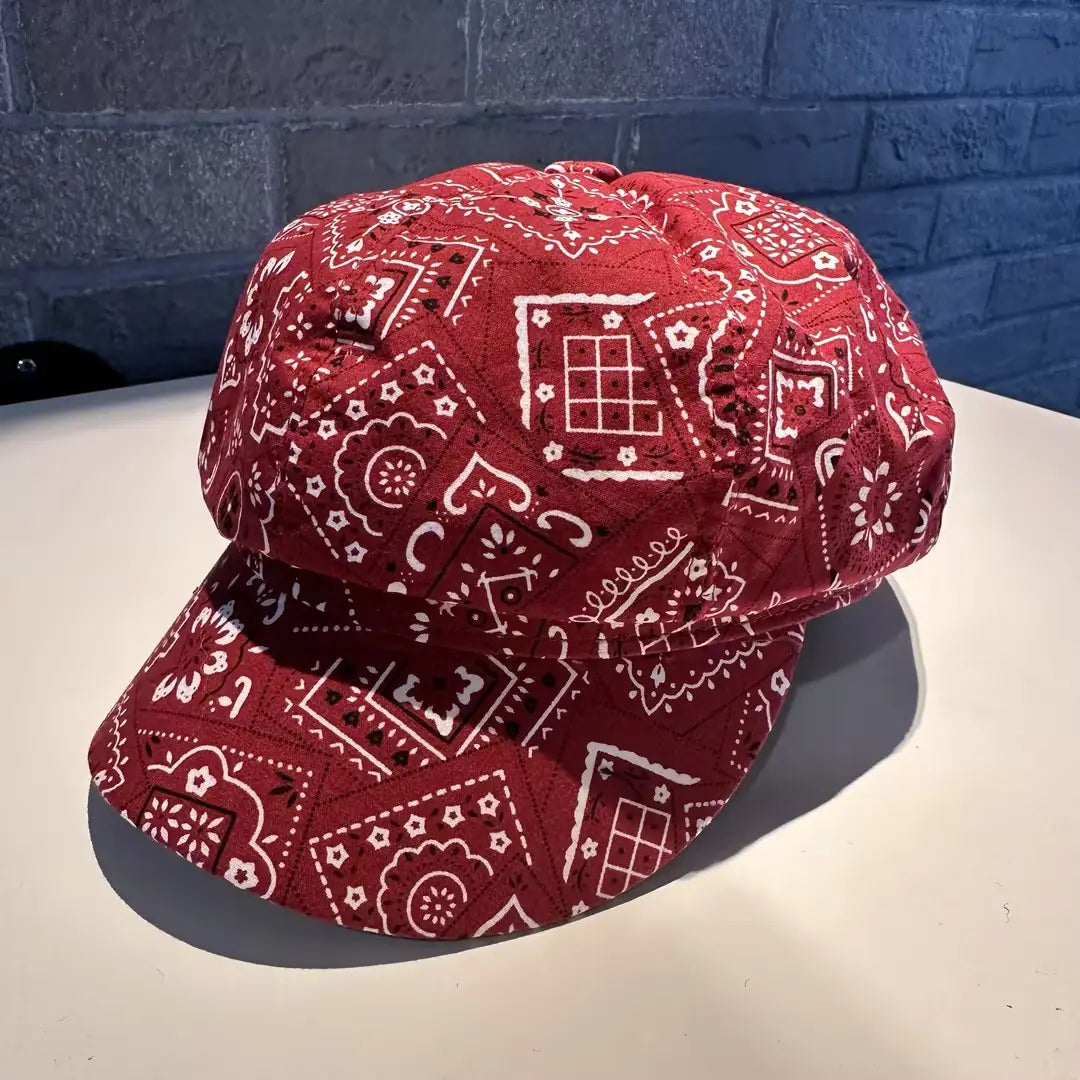 floral newsboy cap for women featuring red bandana-patterned fabric with white and black geometric designs.