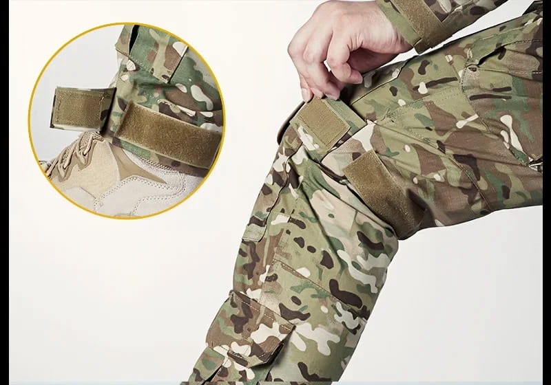 Tactical camouflage cargo pants for men in Multicam pattern featuring adjustable velcro straps and reinforced stitching for durability.