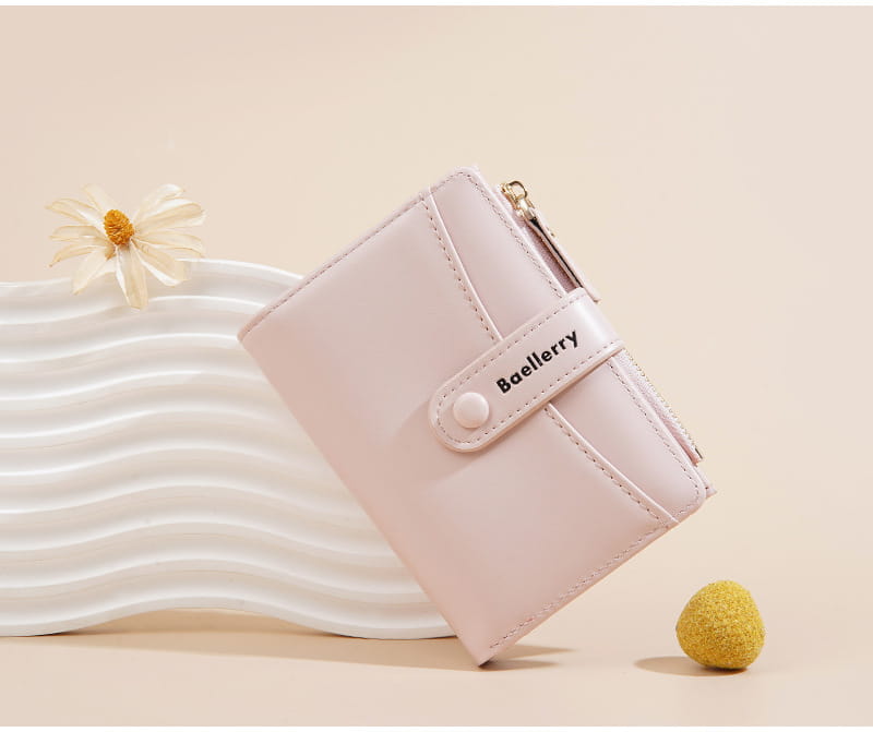 Una cartera de mujer Baellerry rosa pálido, con exterior de cuero PU liso y acabado mate, y cierre sutil con botón blanco.