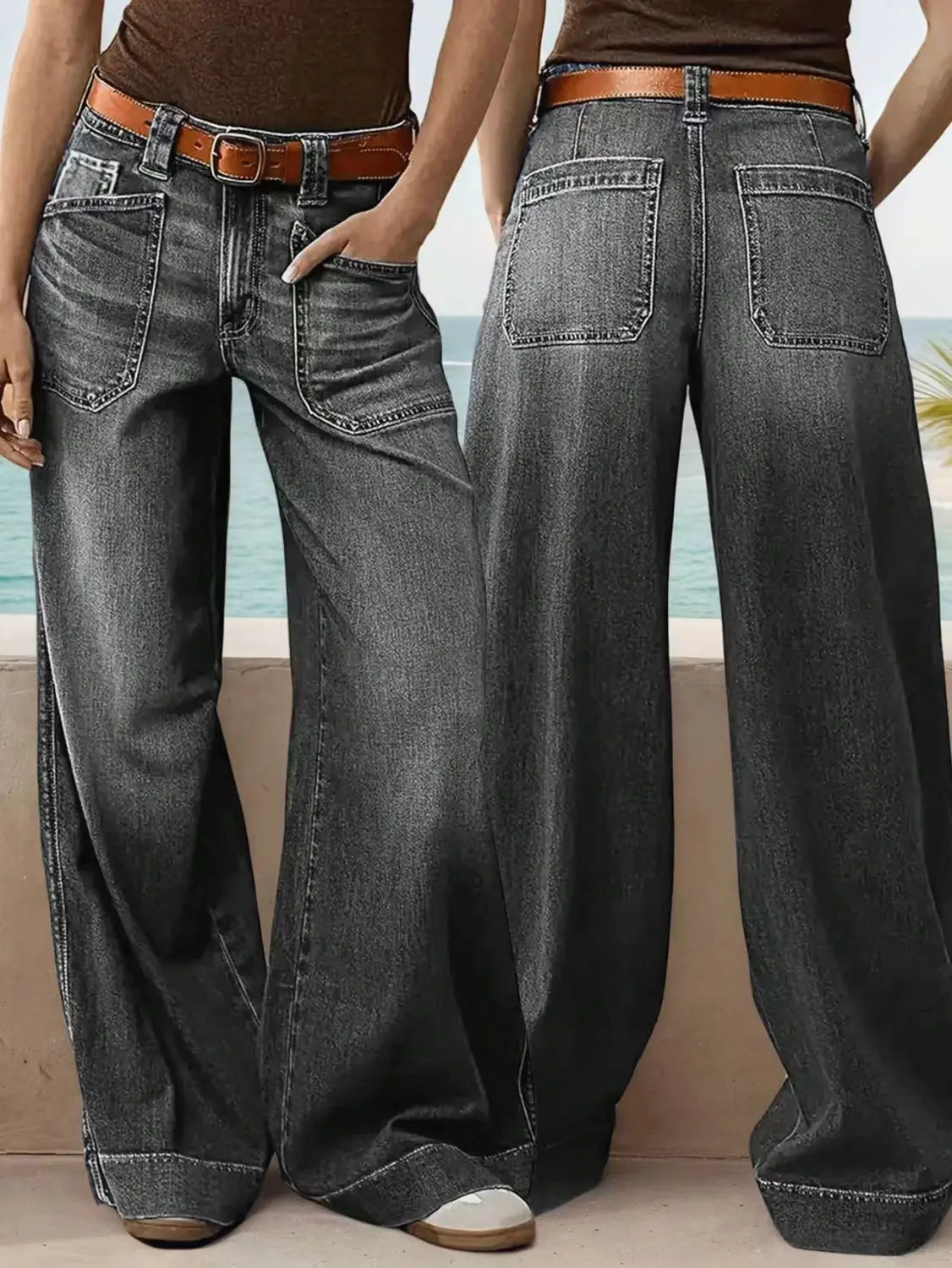 Dark gray wide leg denim pants made of denim fabric paired with a brown leather belt.