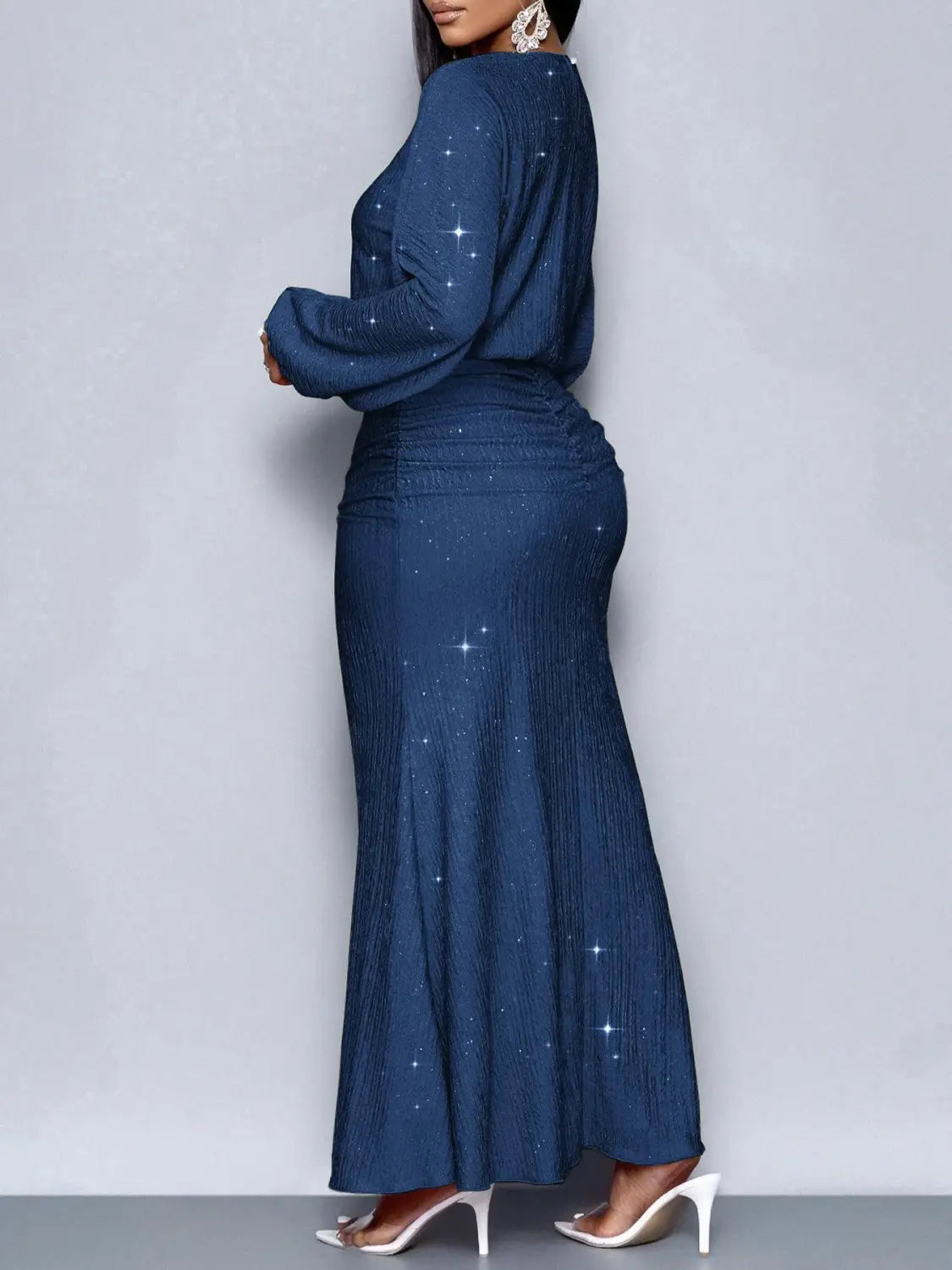 A navy blue floor-length sequin dress with long sleeves, a fitted waist, a pleated skirt, and star-like embellishments from the Sequin Lantern Sleeve Mermaid Two Piece Set.