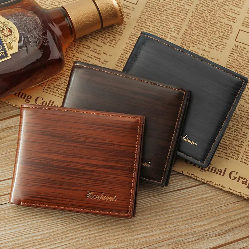 Men’s leather bifold wallet in brown with wood-grain texture and stitched edges featuring card slots and an ID window.