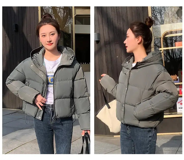 Women hooded short down jacket in olive green quilted puffer style with front zipper for cold weather.