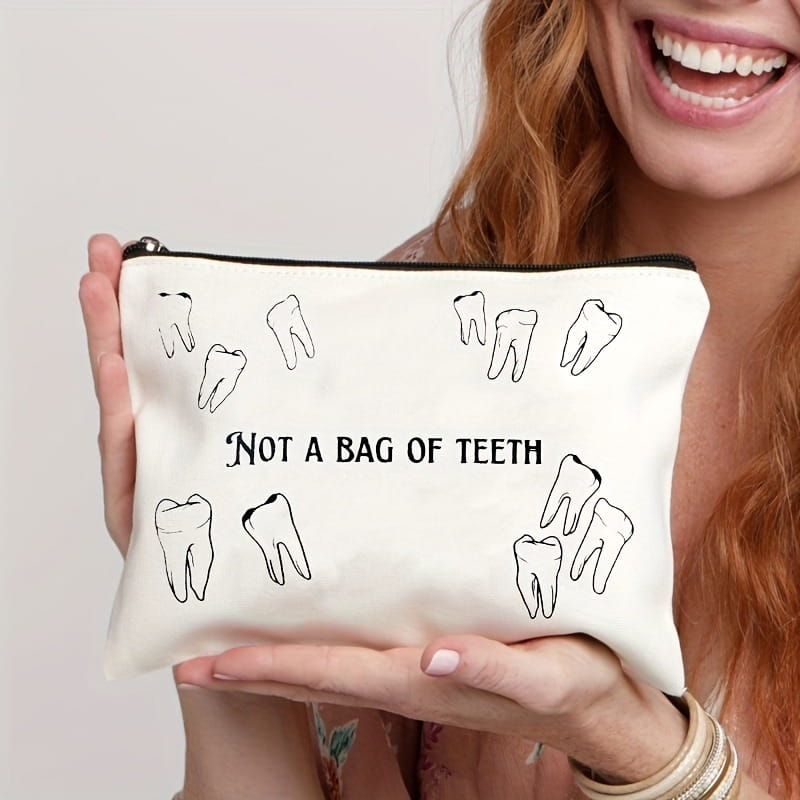 White canvas tooth pouch featuring black tooth illustrations and the text not a bag of teeth for travel use.