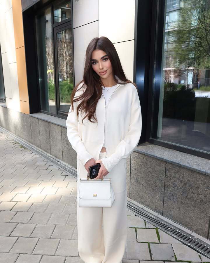 white leather mini handbag with gold tone hardware paired with women’s knit zip up cardigan and wide leg pant set for stylish casual wear.
