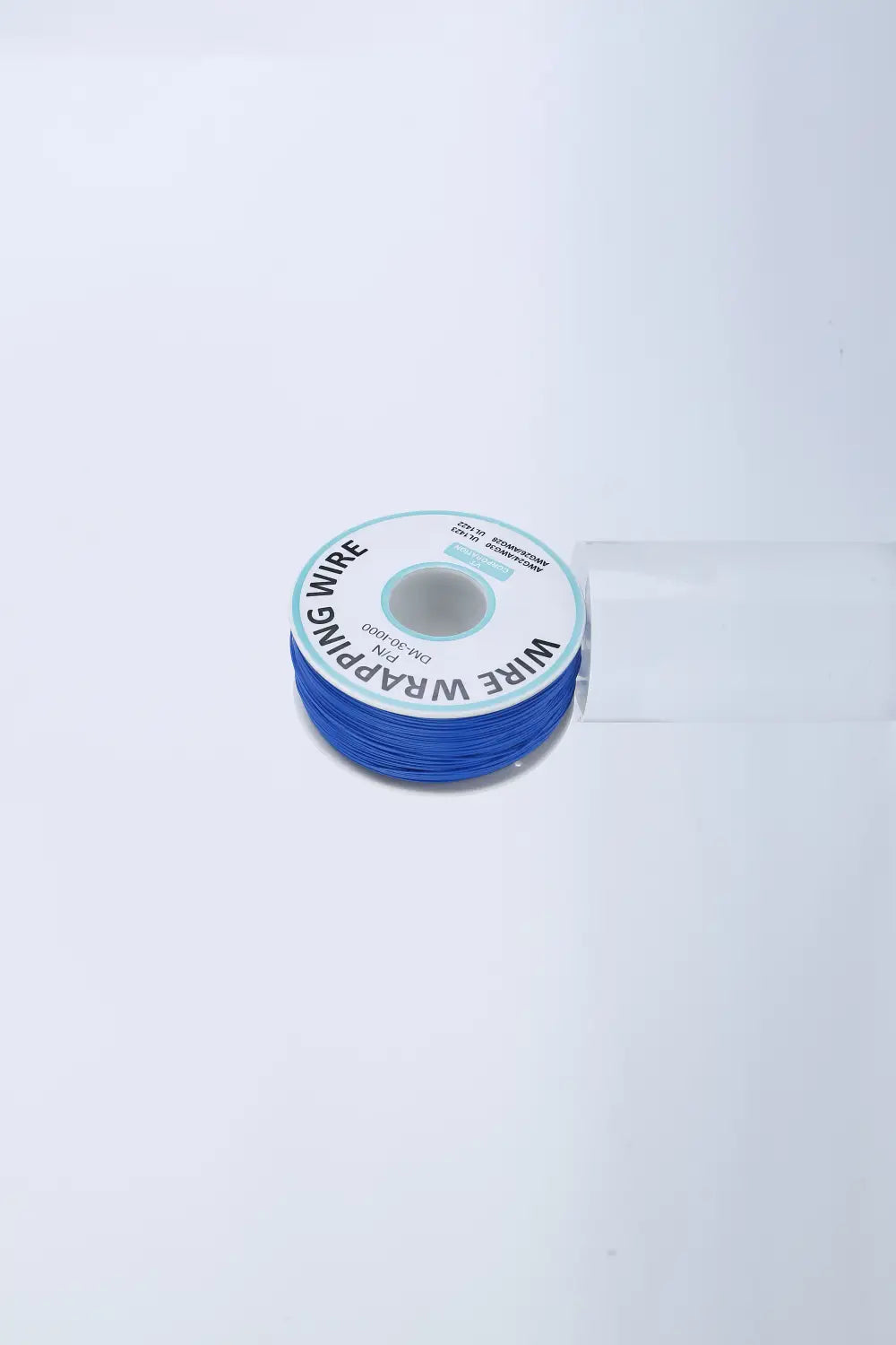 A spool of vibrant blue wire wrapping wire for electric dog fence system with water resistant collar neatly wound and labeled with a white circular sticker.