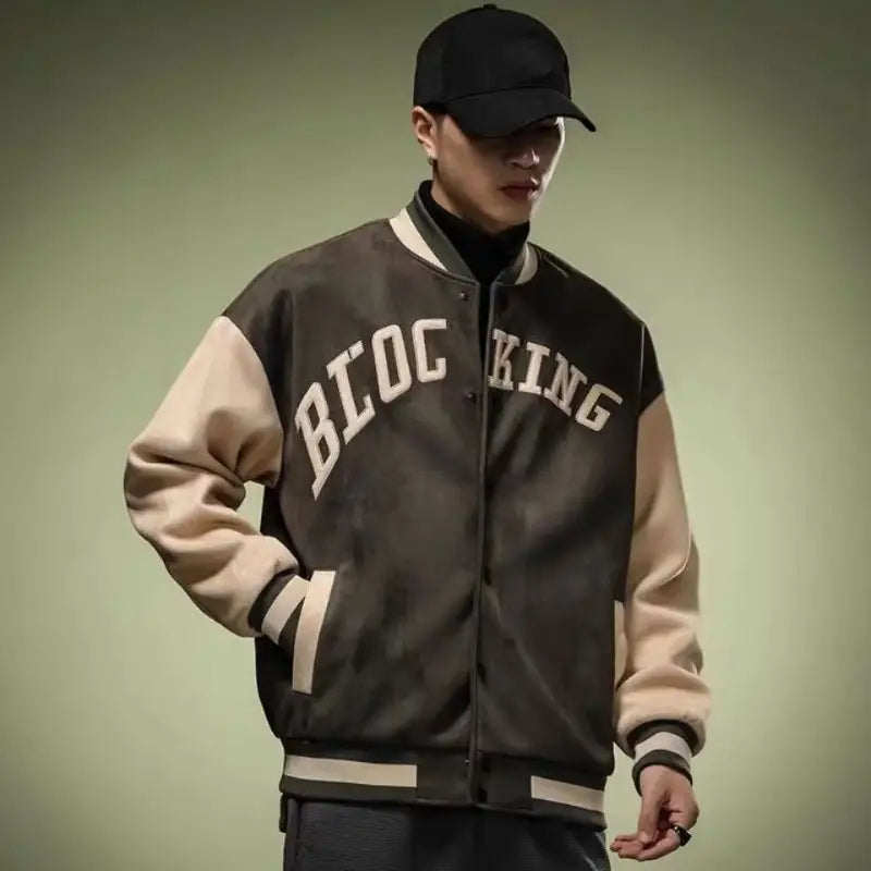 Black and beige varsity jacket with bloc king lettering across the chest designed as a Korean style loose casual top.