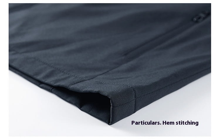 Black quilted fabric with neat reinforced hem stitching on a men casual jacket lightweight outdoor windbreaker.