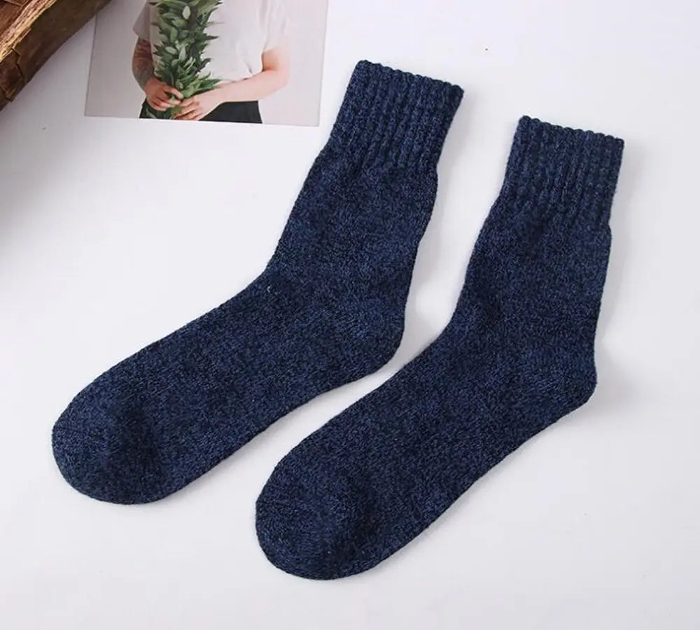 A pair of men’s rabbit fur winter socks in dark navy blue with a ribbed-knit textured and slightly heathered appearance.