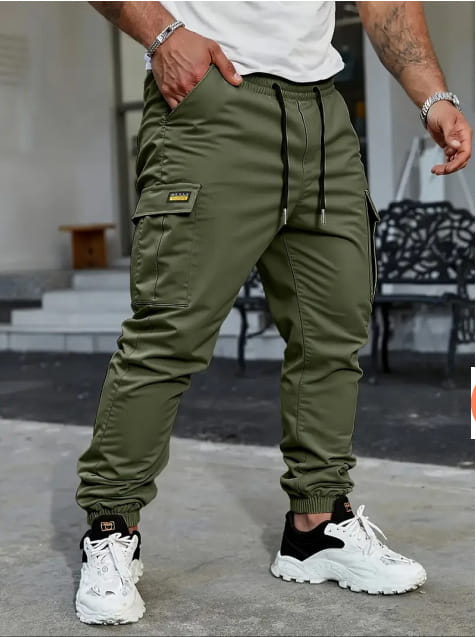 Men’s slim fit cropped olive green cargo joggers with black drawstring waist and yellow logo patch on the thigh.
