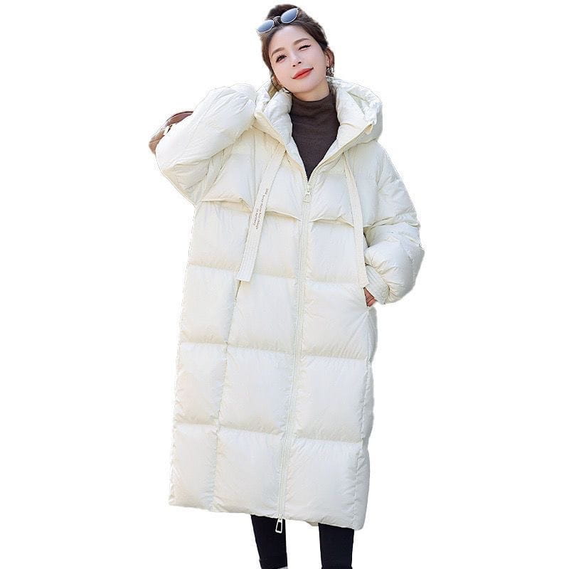 Cream-colored women long hooded puffer coat made of quilted down with a front zipper for warmth and comfort.