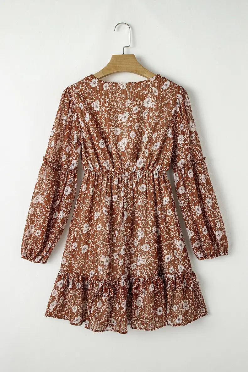 Bohemian rust floral tiered mini dress with puff sleeves in rust-colored fabric featuring a floral print long sleeves and a ruffled hem.