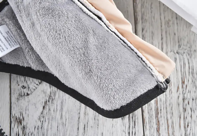 gray plush fleece blanket with soft textured surface and contrasting black binding along the edge for quilted dog vest windproof warm pet coat