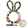 Easter bunny floral wreath for front door made of dark brown woven vine with green leaves pink and white fabric roses and colorful eggs