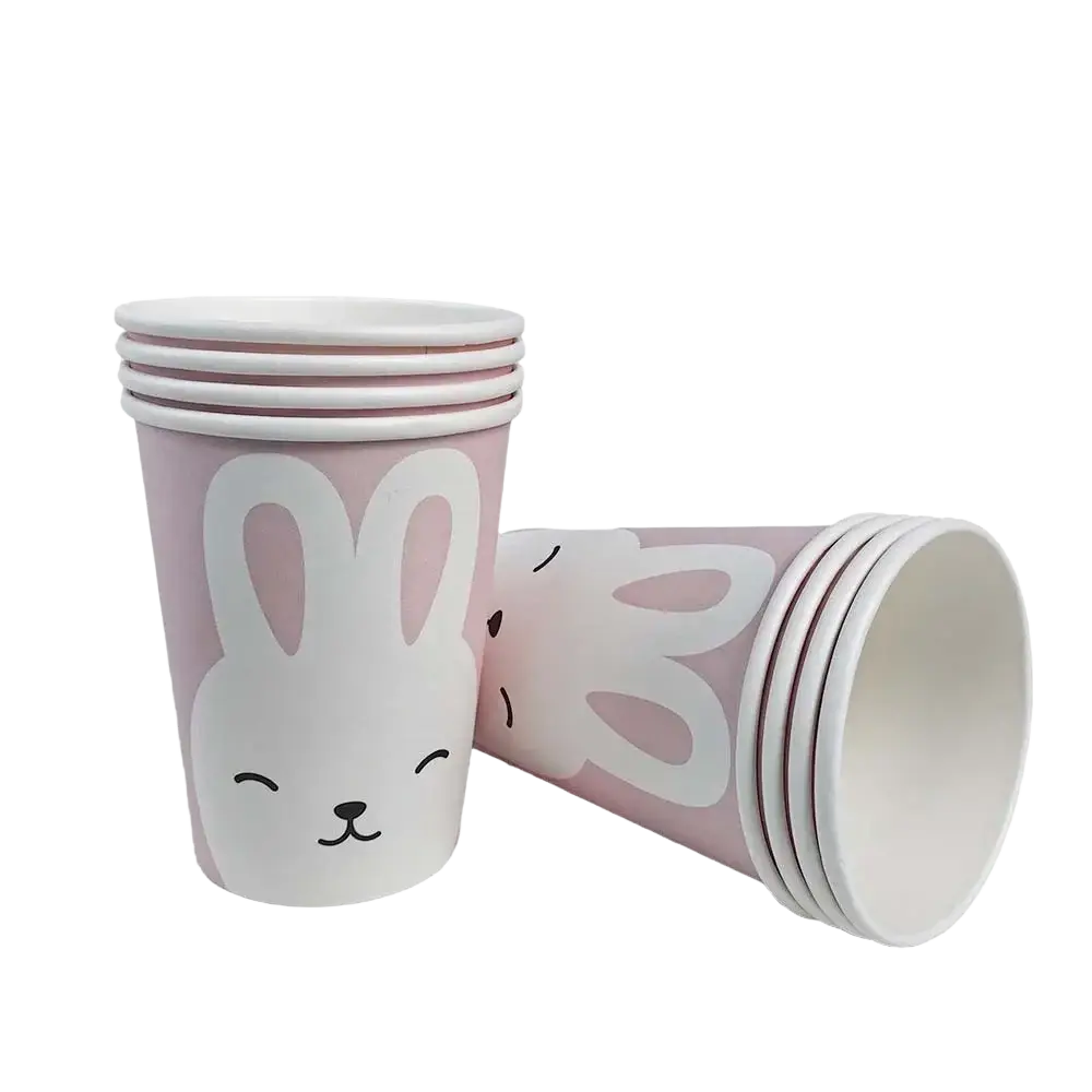 Pink paper cups with white bunny faces and black outlines stacked in a set of eight from Easter Bunny paper plates and cups set