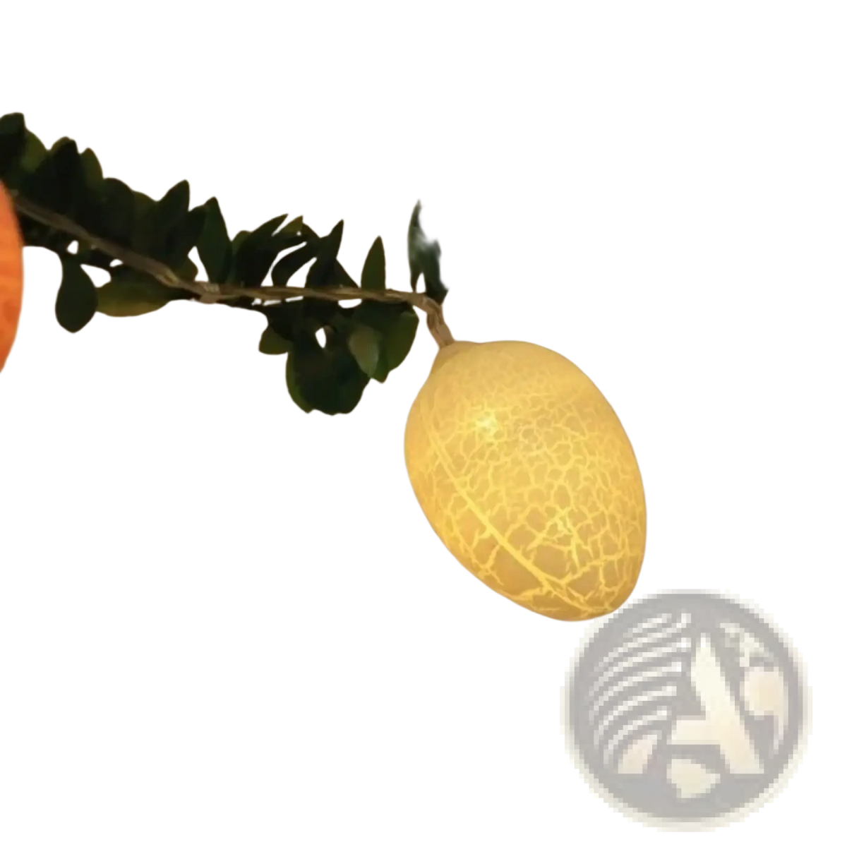A glowing yellow egg-shaped led light with a crackled texture hanging on a green leafy garland for easter decor