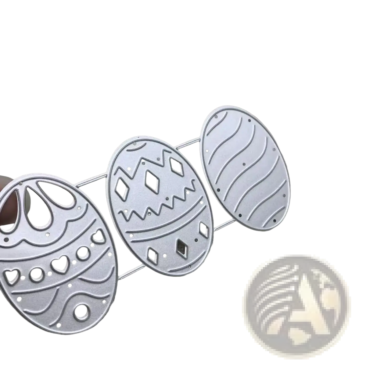 Set of three silver-toned metal easter egg-shaped die-cutting templates with intricate perforated patterns for card making