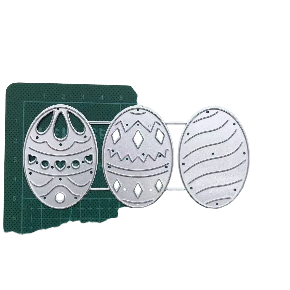 Set of three silver metal easter egg cutting dies with intricate patterns for card making and decoration