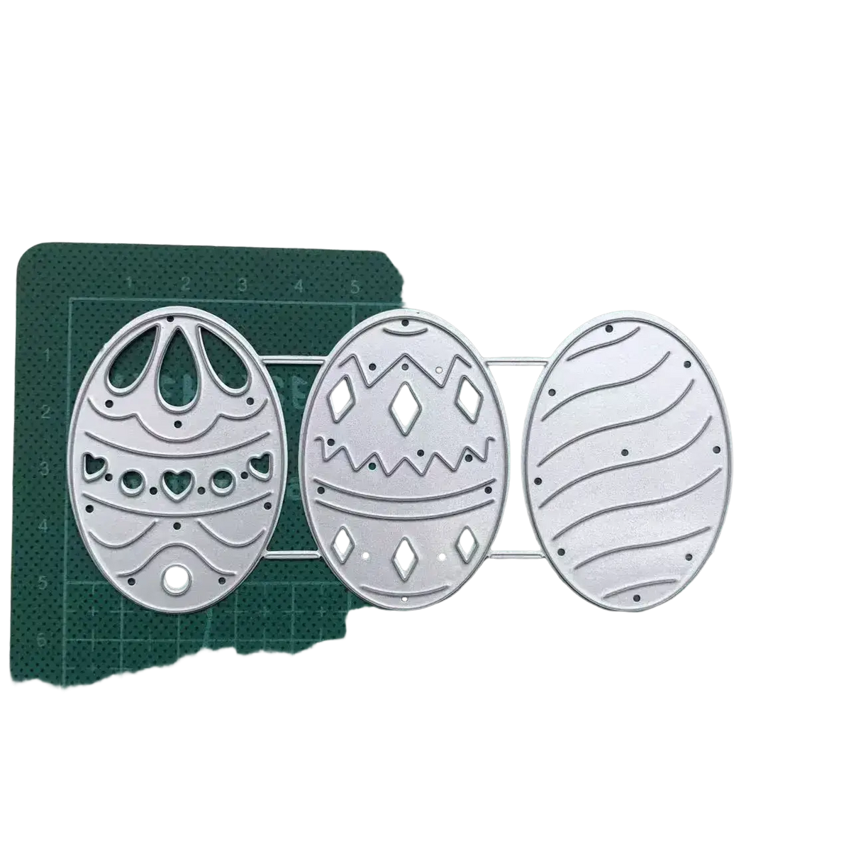 Set of three silver metal easter egg cutting dies with intricate patterns for card making and decoration