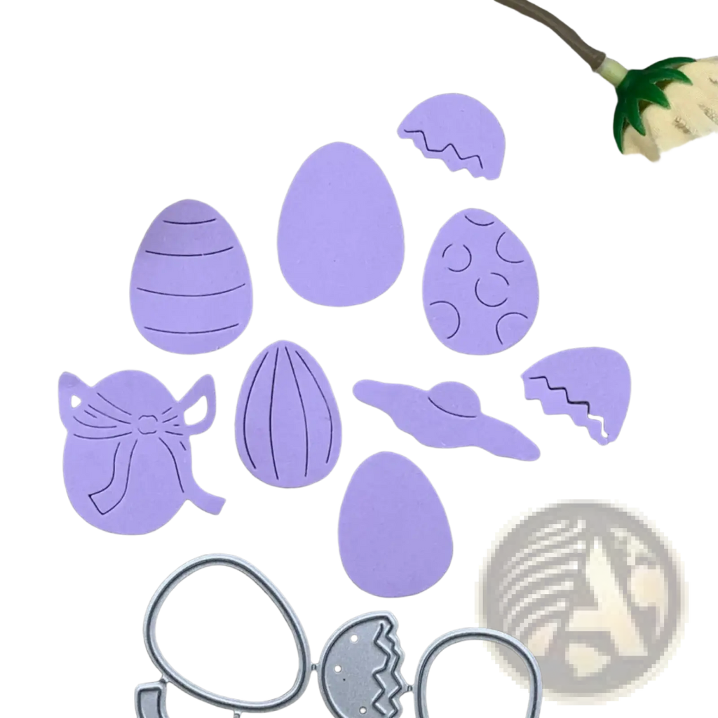 Purple easter egg-shaped die-cut paper pieces with decorative patterns and a silver metal cutting template for scrapbooking