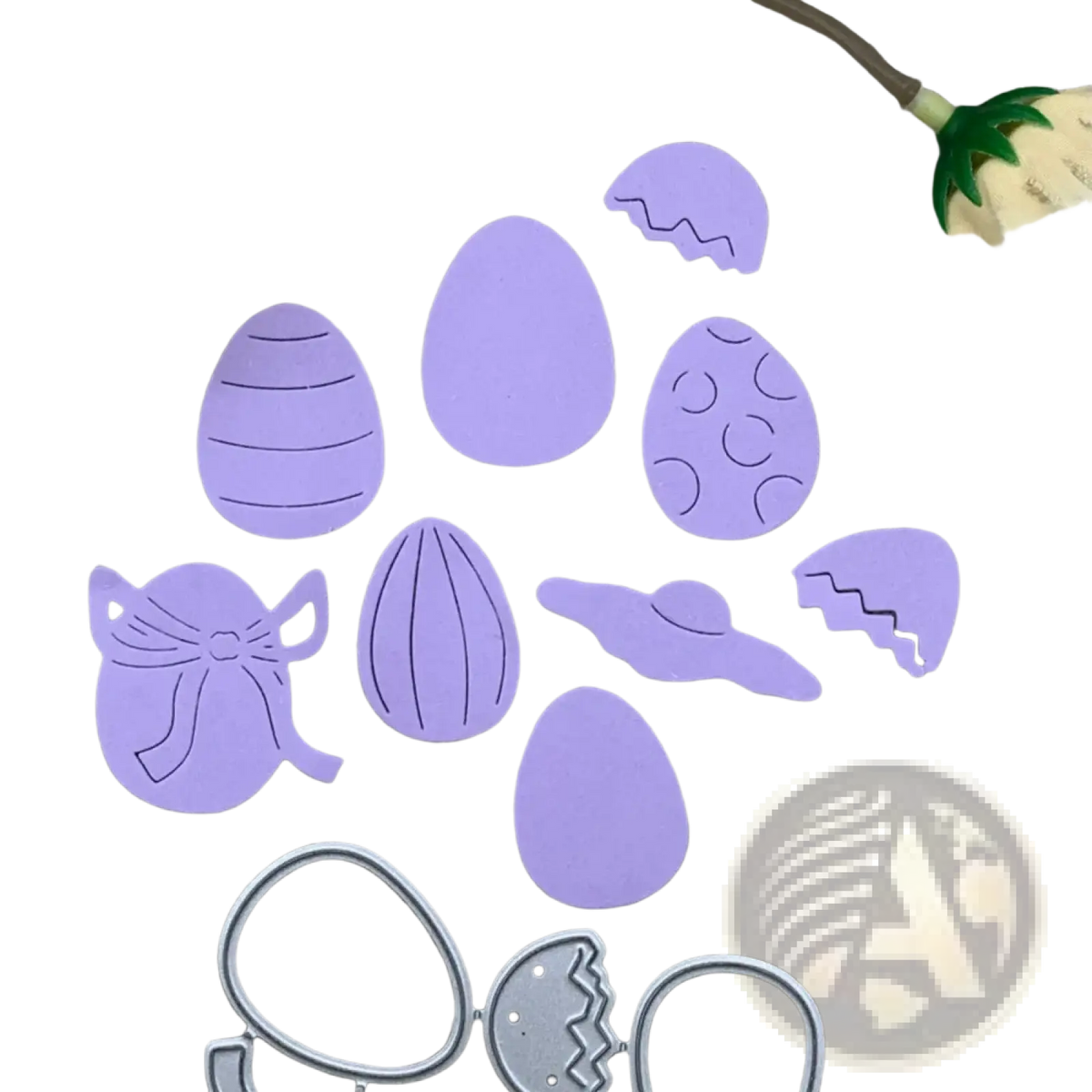 Purple easter egg-shaped die-cut paper pieces with decorative patterns and a silver metal cutting template for scrapbooking
