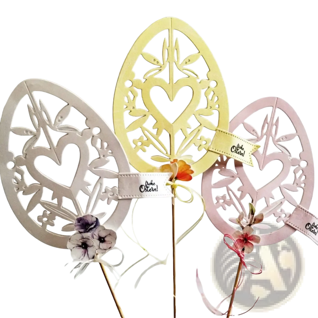 Three metallic floral and heart patterned easter egg cutting dies in cream pale yellow and soft pink for crafting