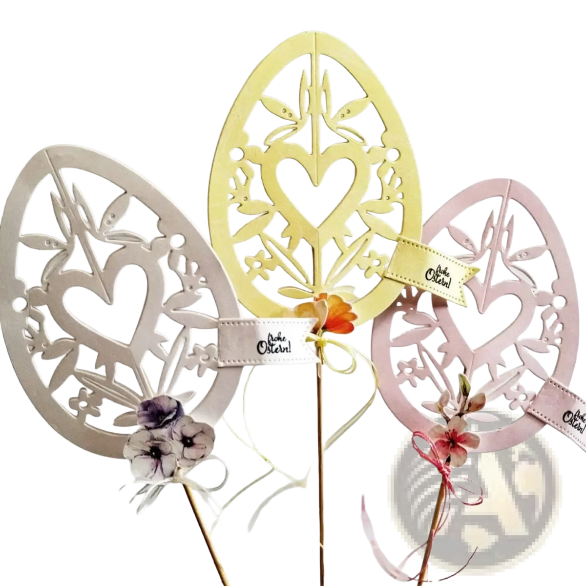 Three metallic floral and heart patterned easter egg cutting dies in cream pale yellow and soft pink for crafting