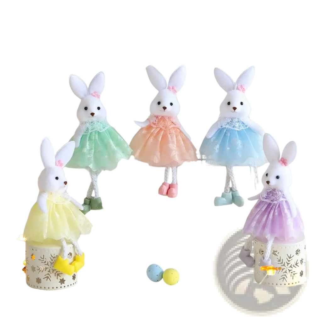 Four plush white bunny ornaments dressed in pastel lace trimmed tulle dresses in green peach blue and purple for easter
