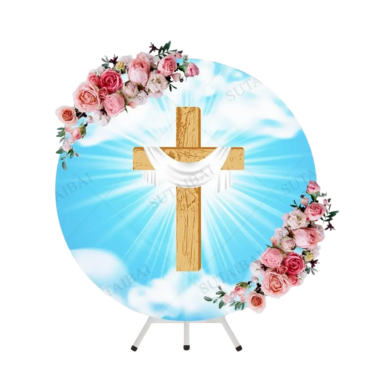 Wooden easter cross with white fabric draped and pink roses on blue sky backdrop titled he is risen round backdrop