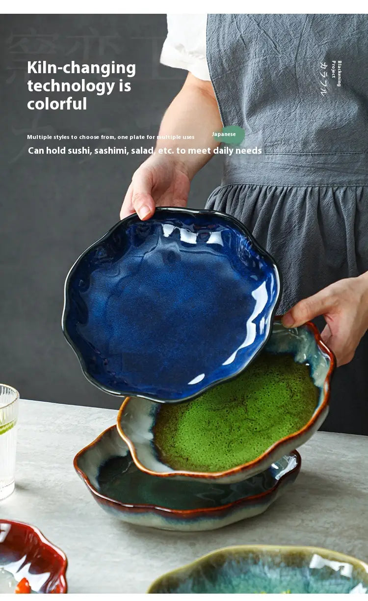Vibrant handcrafted ceramic tableware set scalloped fambe diamond dishes featuring irregular wavy edges and glossy glazes in deep blue green and red hues.